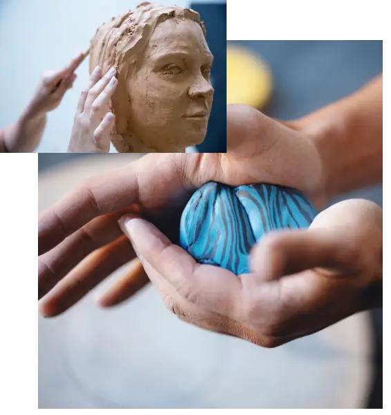 Hands sculpting a blue clay flower beside a clay face model.