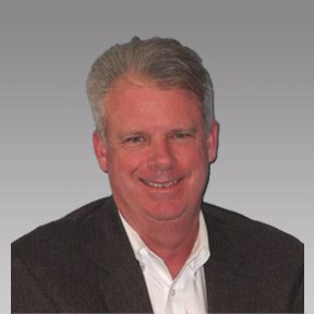 Professional headshot of a smiling middle-aged man with gray hair.